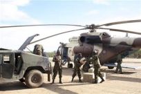 Kenya troops move supplies from a helicopter at the Garrisa airstrip near the Somali-Kenya border