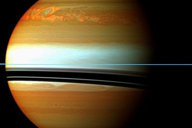 NASA handout image shows Saturn's atmosphere and its rings in a false color composite made from 12 images, captured on January 12, 2011. The mosaic shows the tail of Saturn's huge northern storm