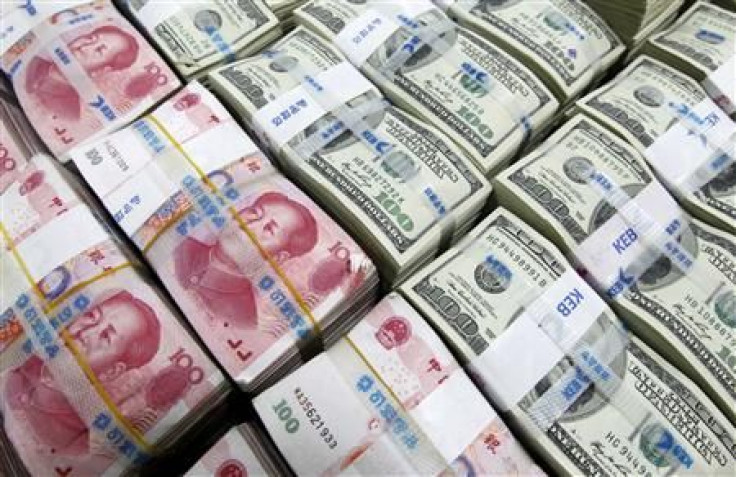 U.S. dollar and Yuan notes are seen in this picture illustration taken at the Korea Exchange Bank in Seoul