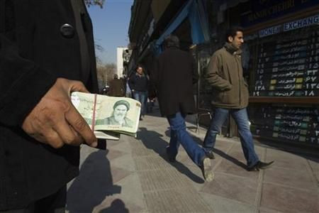 Iranian holding nearly worthless currency