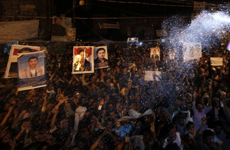 Foam is sprayed on anti-government protesters as they celebrate the signing by Yemen's President Ali Abdullah Saleh of a deal to step down in Sanaa