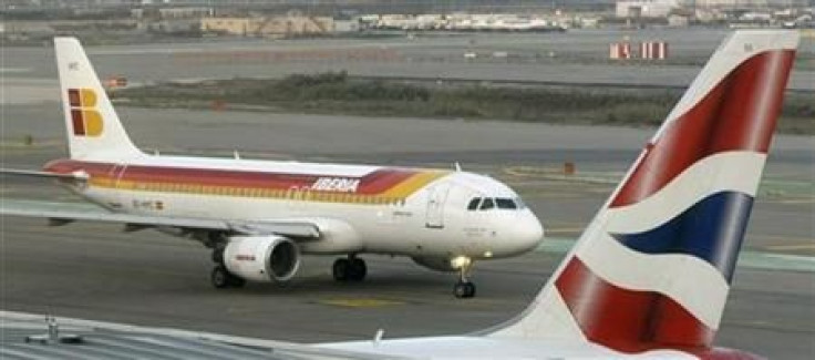 An Iberia jet passes a British Airways jet at Barcelona Airport