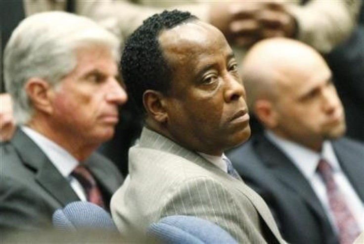 Dr. Conrad Murray remains expressionless next to his attorney J. Michael Flanagan (L) after the jury returned with a guilty verdict in his involuntary manslaughter trial in Los Angeles November 7, 2011.
