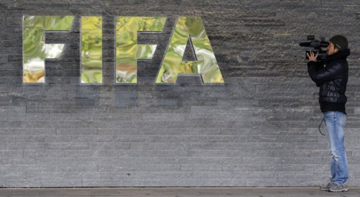 A cameraman films in front of the main entrance of the Home of FIFA in Zurich.