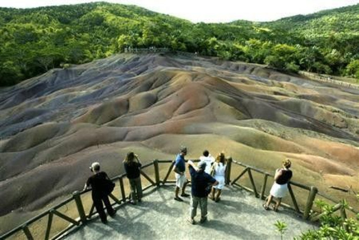 Tourists survey the unusual natural phenomena of the seven-coloured earth at Chamarel in west Mauritius