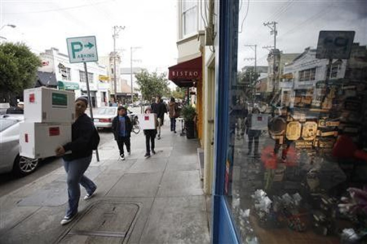 People carrying boxes walk past Chocolate Covered candy shop in the Noe Valley district in San Francisco, California November 21, 2011.