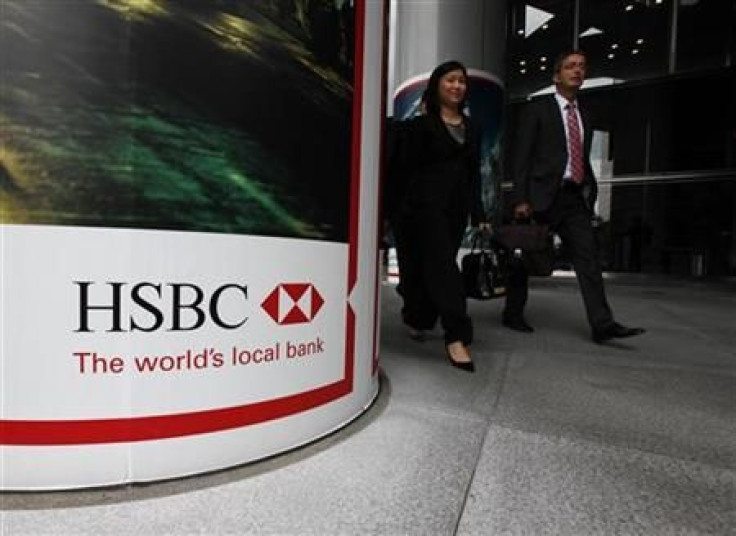 People walk past the entrance to HSBC headquarters in Hong Kong