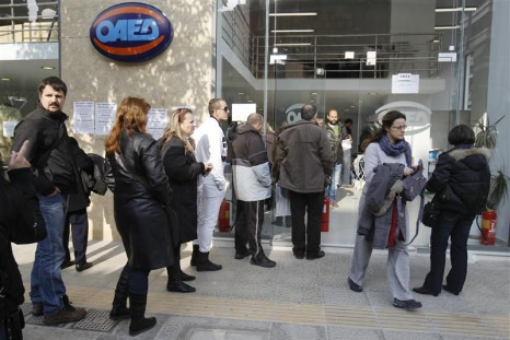 Jobless Greeks wait in line outside an unemployment bureau in Athens