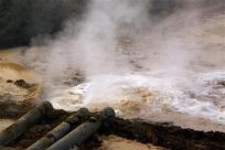 Pipes coming from a rare earth smelting plant spew polluted water into a vast tailings dam near Xinguang Village