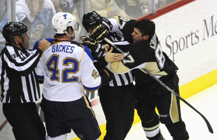 The Pittsburgh Penguins&#039; Crosby battles with St. Louis Blues&#039; Backes while linesmen Champoux and Barton intervene in the second period of their NHL hockey game in Pittsburgh