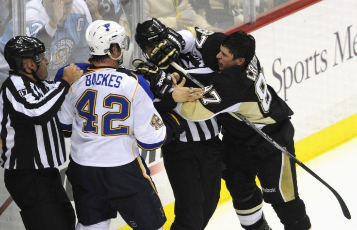 The Pittsburgh Penguins' Crosby battles with St. Louis Blues' Backes while linesmen Champoux and Barton intervene in the second period of their NHL hockey game in Pittsburgh