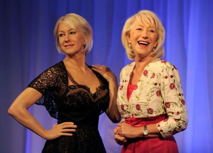 British actress Helen Mirren poses for photographers next to her wax model at Madame Tussauds in London 