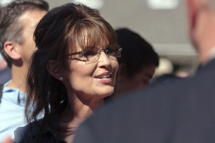 Former Alaska governor Sarah Palin greets supporters as she arrives for the premiere of a documentary about her entitled "The Undefeated" in Pella, Iowa