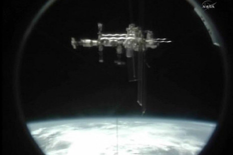 The International Space Station is seen through the docking port of the U.S. space shuttle Atlantis as it departs the station in this still image taken from NASA TV 