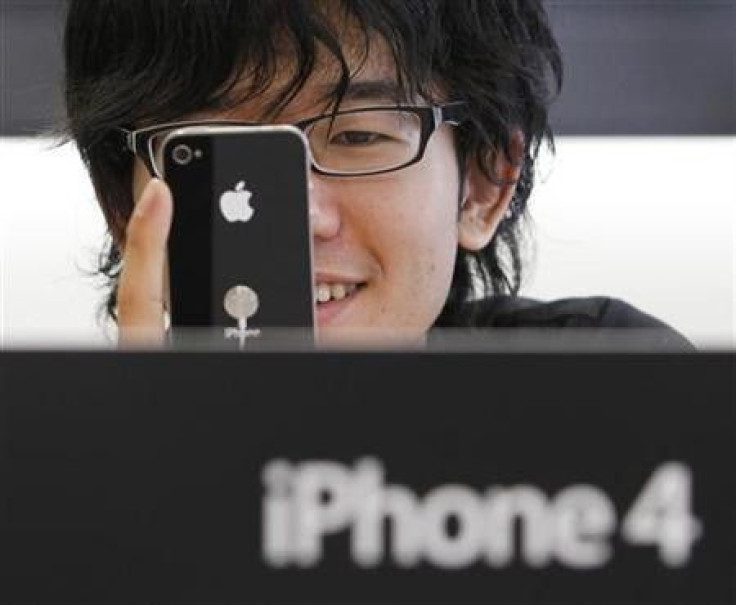 A customer tries out the iPhone 4 at Apple Inc's store in the Ginza district of Tokyo