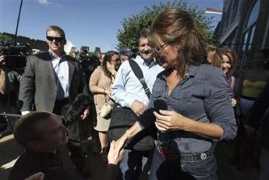 Former Alaska governor Sarah Palin greets supporters as she arrives for the premiere of a documentary about her entitled ''The Undefeated'' in Pella, Iowa