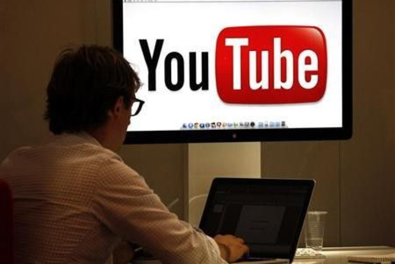 A visitor is seen at the You Tube stand during the annual MIPCOM television programme market in Cannes, southeastern France