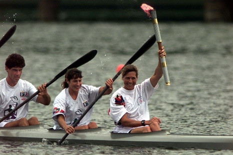 Olympic torch is carried by rowers at the rowing and canoe/kayak competitions venue of Lake Lanier