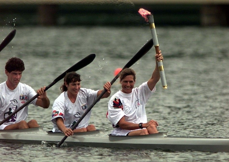 Olympic torch is carried by rowers at the rowing and canoe/kayak competitions venue of Lake Lanier