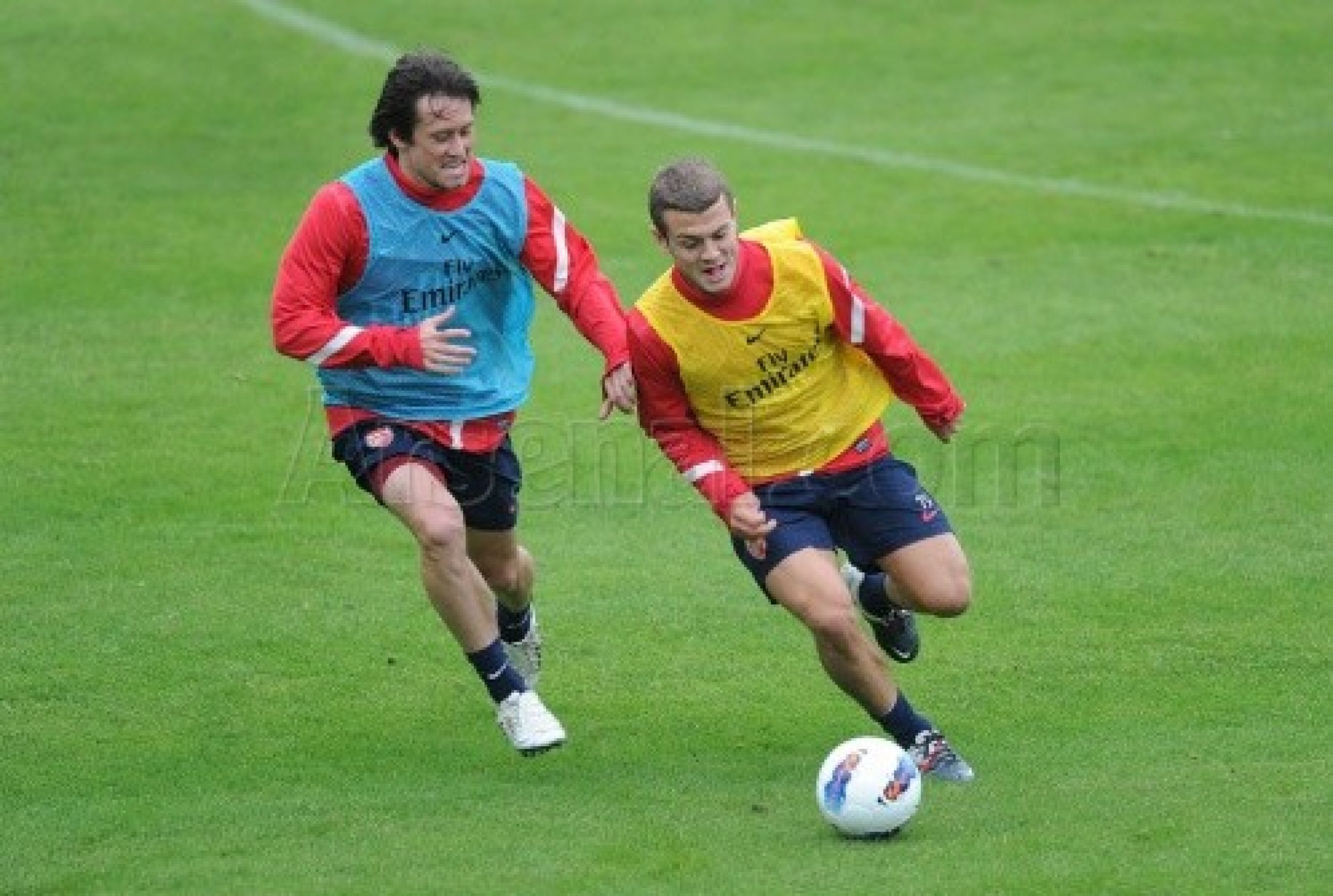 Team mates Tom Rosick and Jack Wilshere battles it out at training.