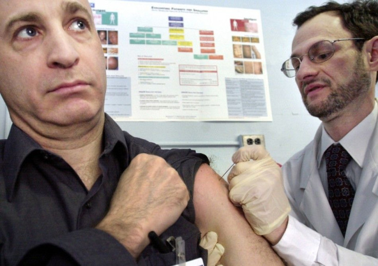 Dr. Stephen Friedman (R) vaccinates his colleague Dr. Don Weiss