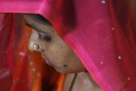 A woman suffering from HIV/AIDS waits to receive vaccine 'Pneumovax' during a vaccination programme organised by non-government organisation 'Sngobadho' (Together) at their office on the outskirts of the northeastern Indian city of Siliguri August 5, 2008