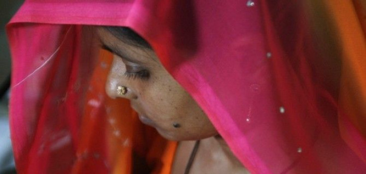 A woman suffering from HIV/AIDS waits to receive vaccine 'Pneumovax' during a vaccination programme organised by non-government organisation 'Sngobadho' (Together) at their office on the outskirts of the northeastern Indian city of Siliguri August 5, 2008