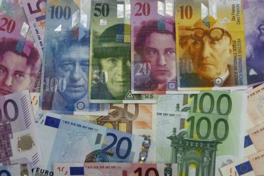 Varoius Euro banknotes lay next to various Swiss Franc notes in this picture illustration at a bank in Warsaw