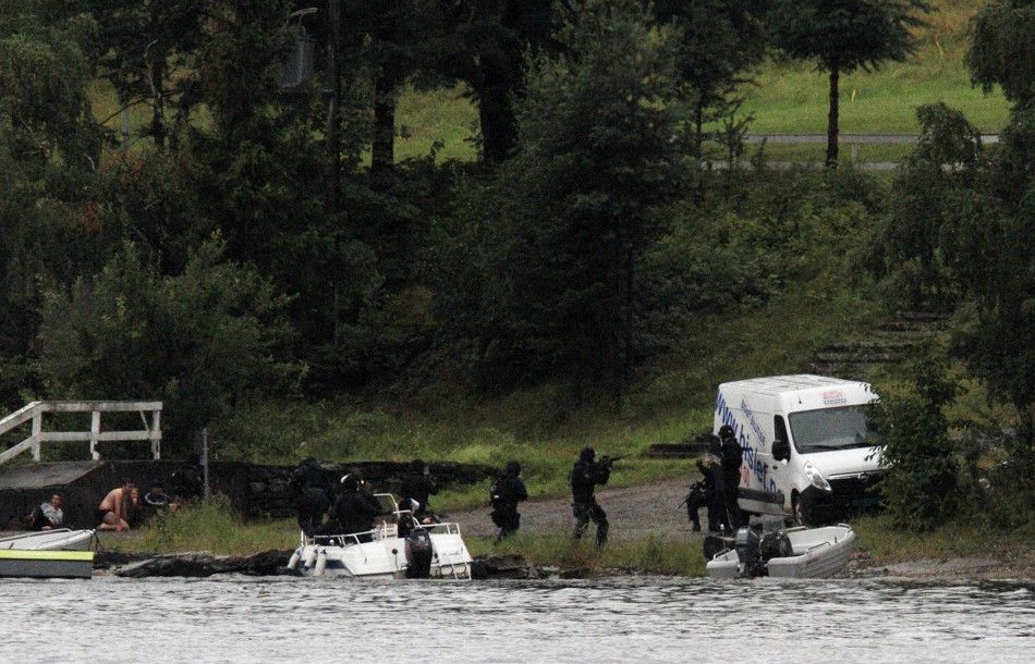 Members of Norwegian Special Forces land by boat on the shore of the island of Utoeya