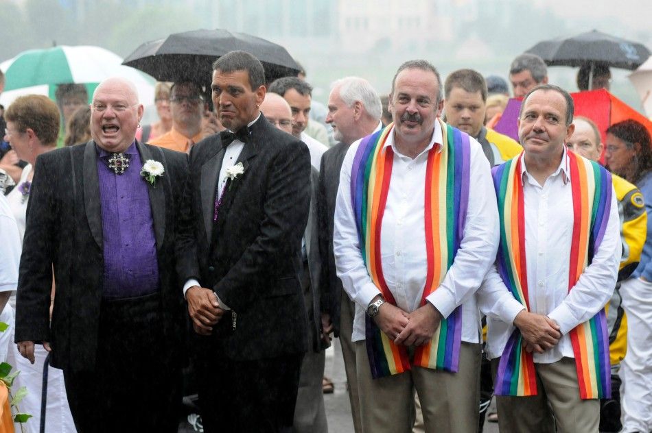 Clyde Phillips-Frey, Nathan Phillips-Frey, Thomas Korn, Mark Lynch are two of forty six couples wed in a large same-sex ceremony, near the brink of Niagara Falls, in Niagara Falls