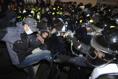 Policemen use pepper sprays on protesters trying to march during a rally in central Seoul