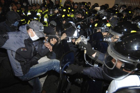 Policemen use pepper sprays on protesters trying to march during a rally in central Seoul