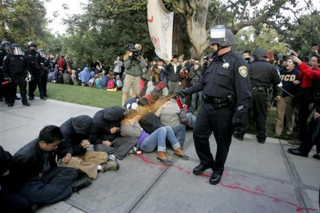 A University of California Davis police officer pepper-sprays students during their sit-in at an &quot;Occupy UCD&quot; demonstration in Davis