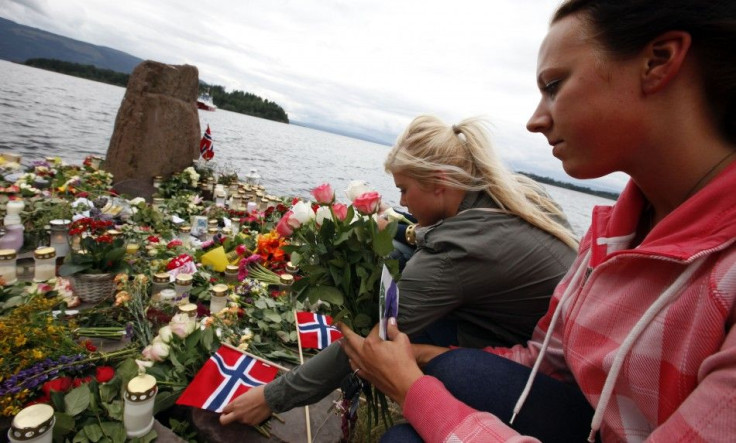 Women lay Norwegian flags