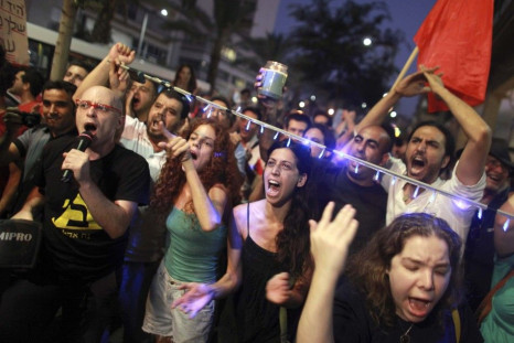 Israelis shout slogans during a march in Tel Aviv against rising property prices in Israel