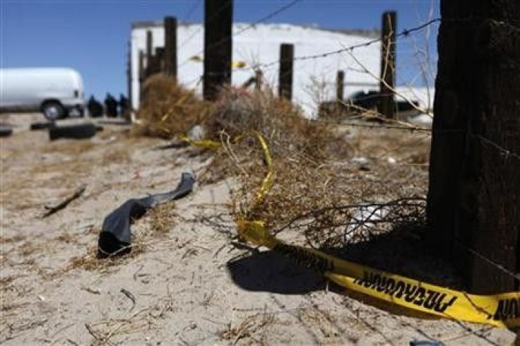 A police cordon is seen at a crime scene where two men were gunned down by unknown assailants on the outskirts of Ciudad Juarez