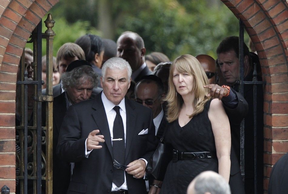 Mitch Winehouse, the father of British singer Amy Winehouse, leaves after her cremation at Golders Green Crematorium in north London