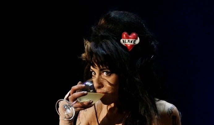 British singer Amy Winehouse drinks while performing during the quotRock in Rioquot music festival in Lisbon May 30, 2008