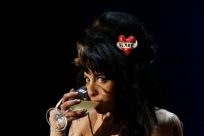 British singer Amy Winehouse drinks while performing during the &quot;Rock in Rio&quot; music festival in Lisbon May 30, 2008