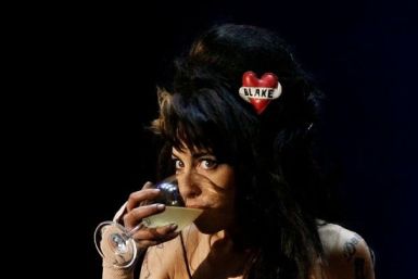 British singer Amy Winehouse drinks while performing during the &quot;Rock in Rio&quot; music festival in Lisbon May 30, 2008