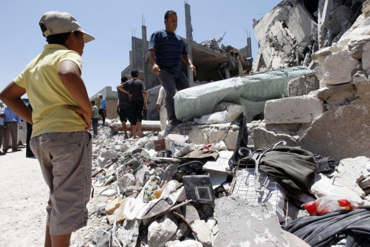 People stand at a house, which was damaged by coalition air strikes according to the Libyan government, in Tripoli