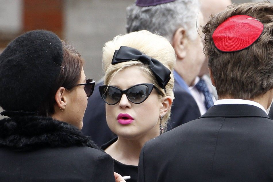 Kelly Osbourne C arrives at Golders Green Crematorium with other mourners for the funeral of British singer Amy Winehouse, in north London 