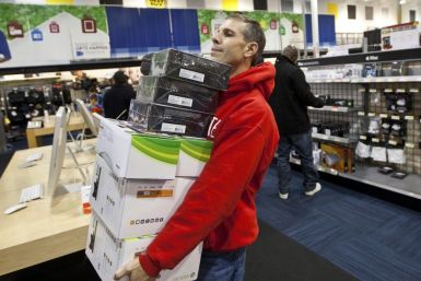 A customer holds an armload of electronics as he waits to check out at a Best Buy store in Pineville, North Carolina