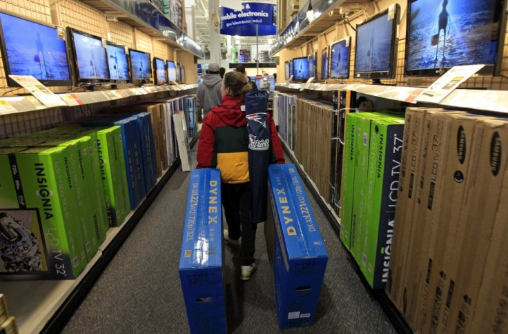 A shopper drags boxes of televisions through the aisles at Best Buy on the shopping day dubbed "Black Friday" in Framingham