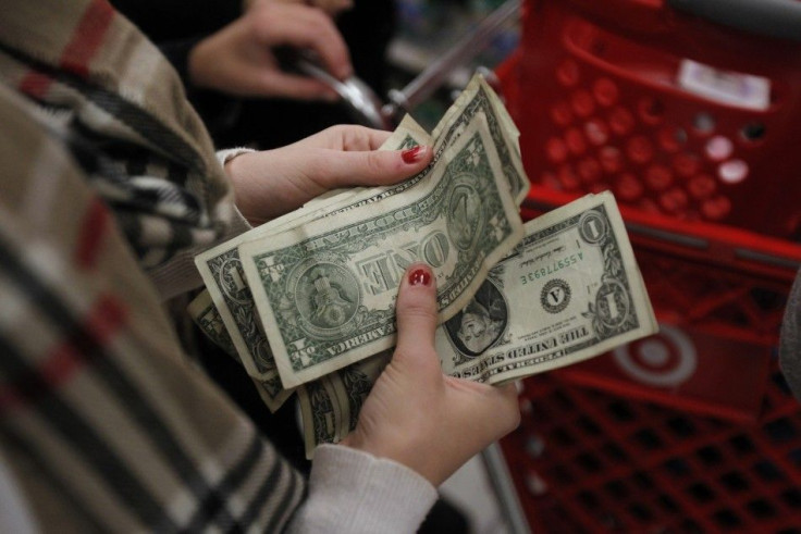 A customer counts her money while waiting in line to check out at a Target store on the shopping day dubbed &quot;Black Friday&quot; in Torrington