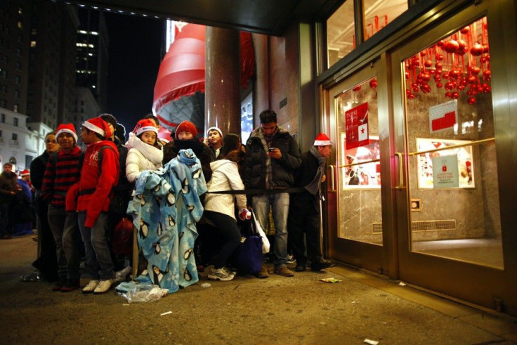 Customers wait for the midnight opening of Macy's department store in New York