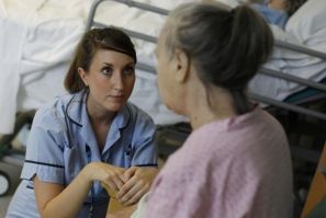 Health Care Assistant Sophie Dorrington talks to a patient in the stroke ward at Hinchingbrooke Hospital in Huntingdon