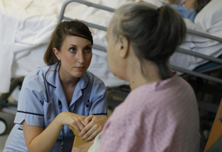 Health Care Assistant Sophie Dorrington talks to a patient in the stroke ward at Hinchingbrooke Hospital in Huntingdon