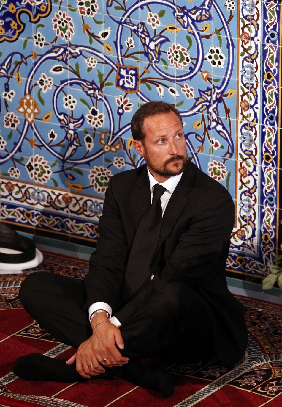 Norways Crown Prince Haakon sits inside the World Islamic Mission Mosque in Oslo