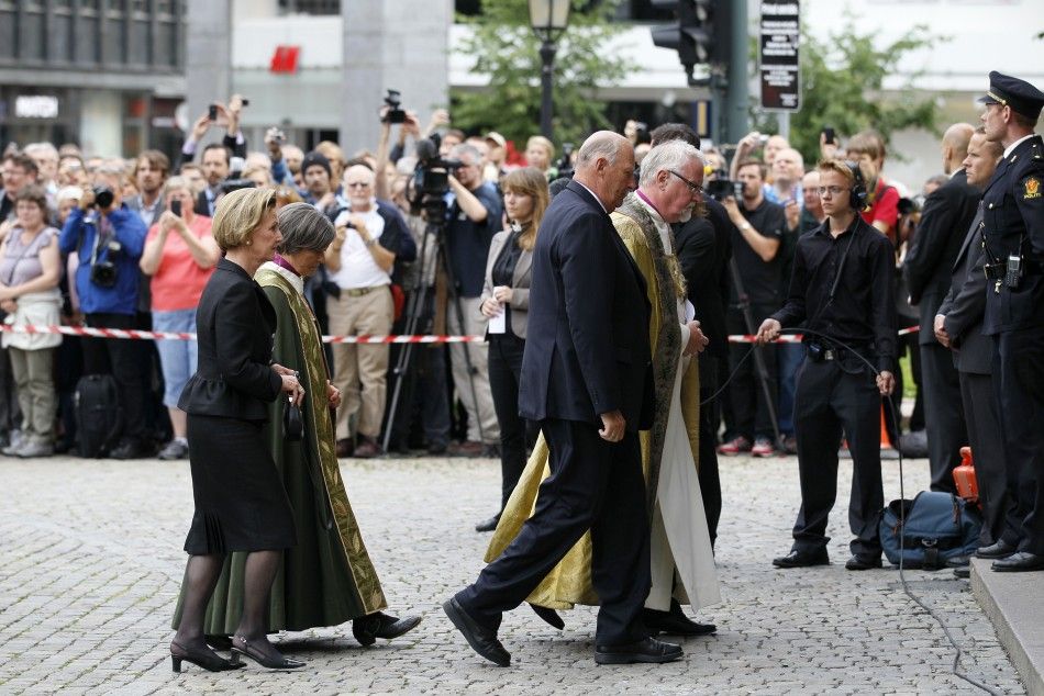 Norwegian King Harald and Queen Sonja arrive to attend a memorial service at a cathedral in Oslo